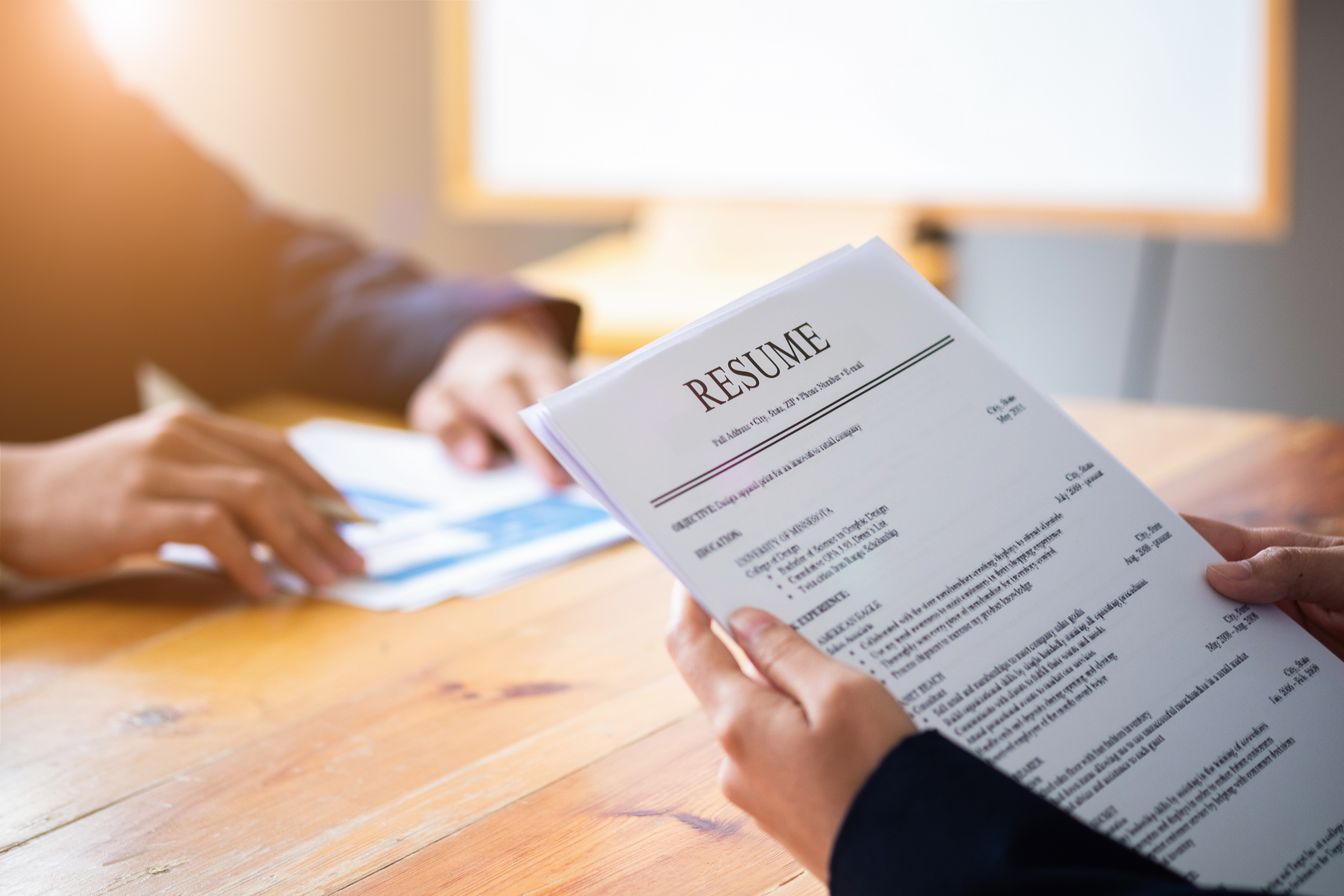 Interviewer reading a resume, Person submits job application, Person describe yourself to interviewer, Close up view of job interview in office, focus on resume, recruiter considering application, hr manager making hiring decision